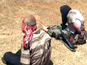 A handout image grab released by the Syrian Arab News Agency (SANA) on Friday allegedly shows blindfolded rebel fighters detained after a Syrian army ambush in the area of Shamsin in the rebel stronghold of Qusair. AFP/SANA