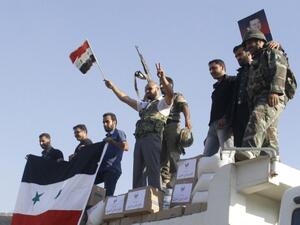 Syrian troops stand victorious in the rubble of Qusair on Wednesday. AFP Photo