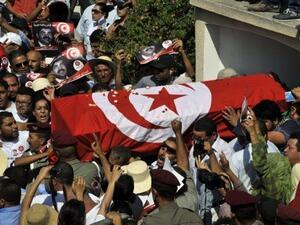 Tunisian mourners carry the coffin of assassinated opposition leader Mohamed Brahmi on Saturday. (AFP)