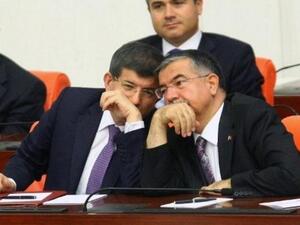 Turkish foreign minister, Ahmet Davutoglu cozies up to his defence minister during a debate on Syria
