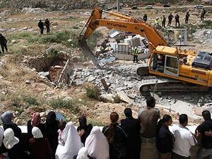 Palestinians watch an Israeli excavator destroying a Palestinian house in a village in the West Bank. (Photograph: Ahmad Gharabli/AFP/Getty images)
