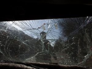 Glass is smashed on a car as Afghan soldiers block the scene after a suicide bomber&amp;#039;s attack on January 12, 2011 in Kabul.