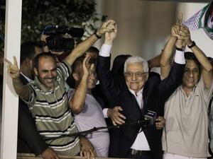 Palestinians cheer at the release of prisoners. (Getty)