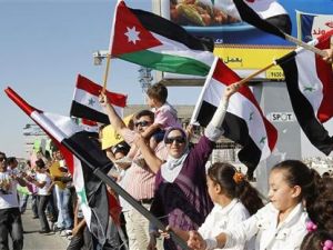 سوريون مقيمون في الاردن يرفعون اعلاما سورية واردنية ويرددون هتافات مؤيدة للرئيس السوري بشار الاسد أمام السفارة السورية في عمان 
