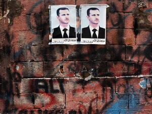Syrian president Bashar al-Assad's picture hangs on a wall in a poor area of Beirut with a high concentration of Syrian refugees.