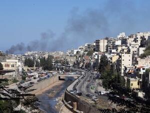 Smoke rises from above Tripoli's predominantly Sunni Bab Al-Tabbaneh neighborhood following days of fatal clashes with the Alawite neighborhood of Jabal Mohsen (Joseph Eid/AFP)