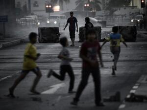 Bahraini boys run for cover during clashes following an anti-regime rally in support of political activists held in prison in the village of Jidhafs, west of Manama on Monday. (Photo:  AFP /MOHAMMED AL-SHAIKH) - Photo used for illustrative purposes - 