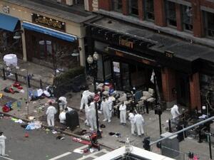 Investigators in white jumpsuits work the crime scene on Boylston Street following Monday's bomb attack at the Boston Marathon. (Photo: Darren McCollester/Getty Images/AFP) 