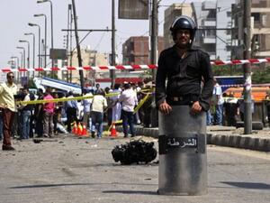An Egyptian policeman stands guard near the scene of a bomb that targeted the convoy of Egyptian Interior Minister Mohammed Ibrahim in Cairo on September 5, 2013. An Al Qaeda inspired group have claimed responsibility for the attack. (AFP)