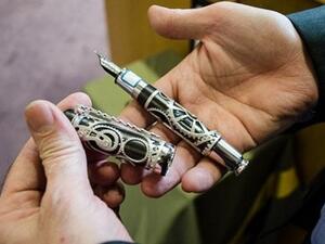 The president is using a Mont Blanc pen, which commemorates the life of Charlie Chaplin, to fund homes for the country’s war veterans and single mothers. (Image courtesy: Iran State News Agency)