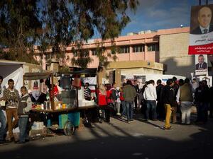 Coffee vendors try to profit from election day, pitching up in a busy polling station in central Amman
