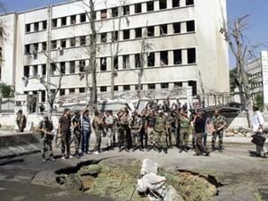 Soldiers look on as Damascus explosion leaves ground in ruins