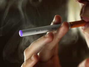 A woman smokes an e-cigarette (Getty image used for illustrative purposes)