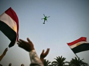 An Egyptian military helicopter flies over a rally on July 7, 2013. (Source: KHALED DESOUKI / AFP)