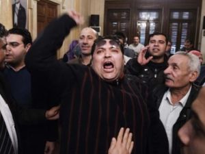 An unidentified Egyptian man shouts slogans against Egypt's President Mohamed Morsi and in support of an election boycott during a meeting of leaders from the Egyptian National Salvation Front (NSF) in Cairo in February. (Photo:  AFP / Gianluigi Guercia)
