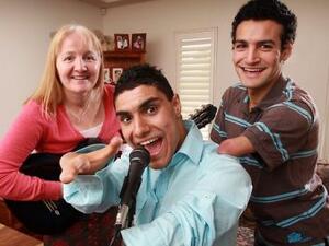 Emanuel Kelly and brother with their Australian adoptive family.  Emmanuel and his brother suffer from limb deficiencies.