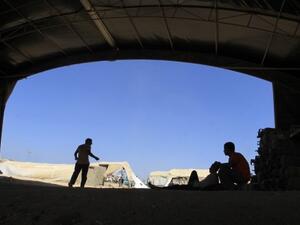  A Palestinian worker rests at the entrance of a smuggling tunnel dug beneath the Gaza-Egypt border in the southern Gaza Strip on August 27, 2013. (AFP)