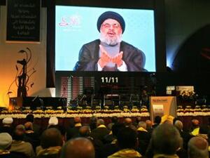 Hezbollah leader Sayyed Hasan Nasrallah speaks on a TV screen during a ceremony in Beirut  (The Daily Star/Hasan Shaaban)
