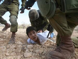 A Palestinian kid was arrested last year for throwing stones at Israeli soldiers (Hazem Bader/AFP)