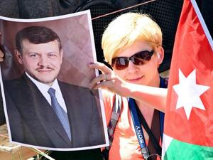 A pro-government supporter holds a picture of Jordan's King Abdullah in Amman in April 2012. (Photo: Muhammad Hamed)