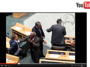 Shady Al-Edwan reaches for his gun during a session of parliament