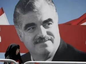 امراة تمر امام ملصق يحمل صورة كبيرة لرفيق الحريري