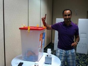 One Libyan proudly shows off his purple finger