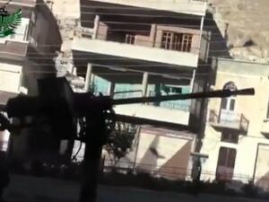  An image grab taken from a video uploaded on YouTube by Shaam News Network on September 4, 2013 allegedly shows a rebel fighter firing a heavy machine gun during a battle in Maaloula. (AFP)