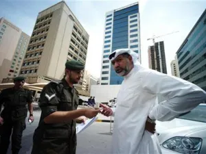 شرطي يتحقق من هوية رجل قبل دخوله لمحكمة في المنامة

