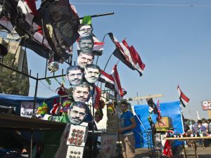 A young Egyptian street vendor sells national flags and masks of deposed president Mohamed Morsi outside Rabaa al-Adawiya mosque in Cairo (AFP/KHALED DESOUKI)