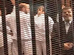 Former president Mohammed Morsi was reportedly "feisty, speaking loudly to the judges and [proclaiming] that he was still the president of Egypt" during Monday's trial (AP)