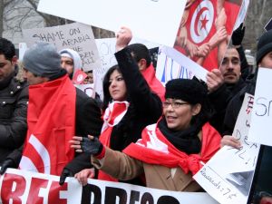 Protesters holding signs and banners. by Merel van Beeren