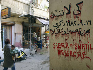 A Palestinian woman passes by a sign marking the 1982 Sabra and Shatila massacre in Beirut, Lebanon [GALLO/GETTY]