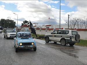 A flag-waving Salafi vigilante group patrols the streets of Tunis in a blue Renault (Photo: Monia Ghanmi) 