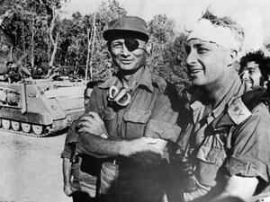 A file picture taken in October 1973 and provided by the Israeli Army shows Ariel Sharon with Moshe Dayan on the western side of the Suez Canal during the Yom Kippor war. [AFP]
