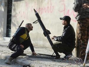 Syrian rebels fire a mortar towards regime forces stationed at Kwiriss airport in Al-Bab, 30 kilometres from the northeastern Syrian city of Aleppo, on Thursday. (AFP Photo/Edouard Elias)