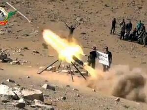 An image grab taken from a video uploaded on YouTube on May 29, 2013 allegedly shows members of the Al-Tawhid brigade firing missiles from Syria towards the Lebanese town of Hermel, a few kilometres from Baalbek in the Bekaa valley. AFP photo/YouTube
