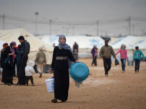 A Syrian woman walking at the Zaatari refugee camp in Jordan (AFP)