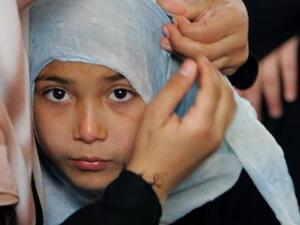 One young girl in Gaza tries on the veil 