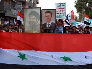 Yemeni supporters of Shiite al-Huthi group hold up a portrait of Lebanon's Shiite movement Hezbollah chief Hassan Nasarallah(L) and of Syria's President Bashar al-Assad during a demonstration in Yemen. (AFP)