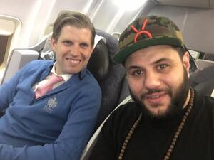Eric Trump seated next to Mo Amer on a flight to Glasgow. (Facebook)