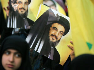 Hezbollah leader Hassan Nasrallah is seen on posters during a rally in Beirut. (AFP/File)
