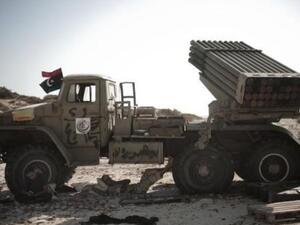 احد المتمردين الليبيين يستريح تحت راجمة صواريخ في البريقة 
