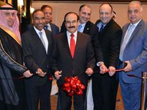 Dr Mirza opens the office, watched by other officials. Image: courtesy BNA.