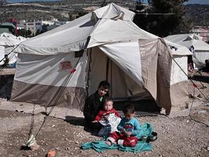 Afghan refugees rest next to their tent at the reception center for refugees in Schisto, near Athens, Greece, February 25, 2016. (AFP/File)  Afghan refugees rest next to their tent at the reception center for refugees in Schisto, near Athens, Greece, February 25, 2016. (AFP/File)