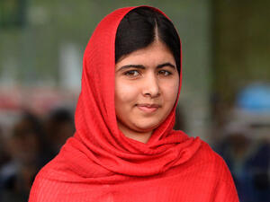 Photo taken on September 3, 2013 shows Malala Yousafzai, the 16-year-old Pakistani advocate for girls education who was shot in the head by the Taliban in 2012, opening the Library of Birmingham. (Image credit: AFP)