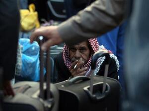 Palestinians wait to cross the border at the Rafah crossing between Egypt and Gaza. (AFP/File)