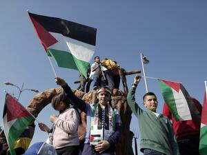 Arab Israelis wave the Palestinian flag during a rally commemorating Land Day on March 30, 2016 in the northern Israeli village of Arrabe. (AFP/Ahmad Gharabli)