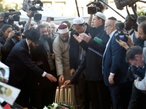 رجال دين مسلمون ويهود يضيئون الشموع امام مسرح باتاكلان
