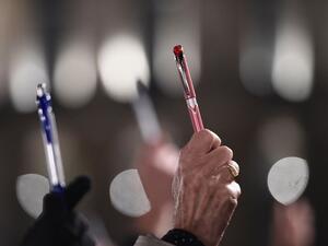 Demonstrators hold up pens in solidarity with last year's slain Charlie Hebdo journalists in France. (AFP/Damien Meyer)